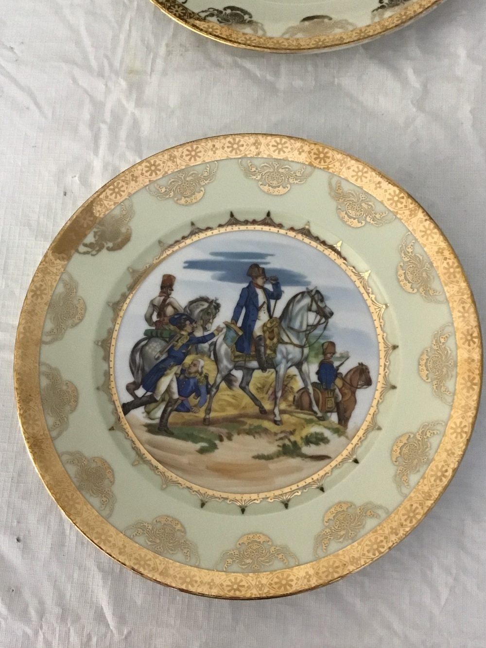 Decorative Gold-Rimmed Pale yellow Porcelain Plate with Napoleon in a battlefied